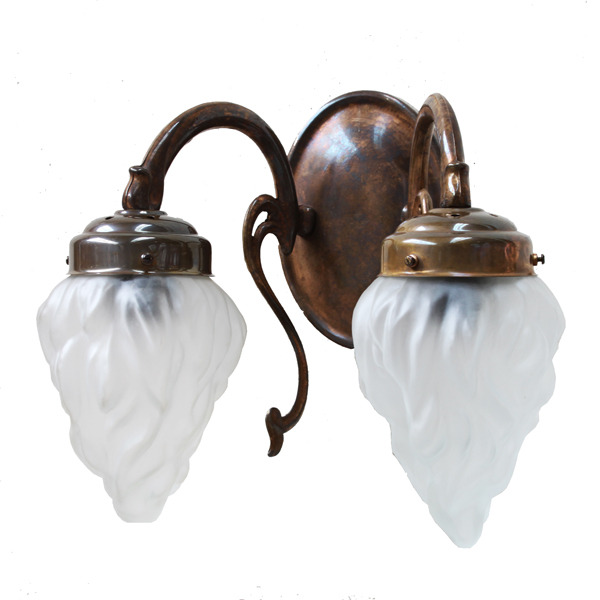 "Manufactured in Ireland, this brass wall light comes complete with frosted flame glass shades which create a warm glow when lit."