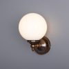 "Add a modern look to your home decor with the Cloghan Modern Globe Wall Light."