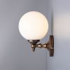 "Add a modern look to your home decor with the Cloghan Modern Globe Wall Light."