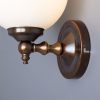 "Add a modern look to your home decor with the Cloghan Modern Globe Wall Light."