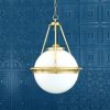 "The Ardee is a traditional glass globe chandelier. An opal glass globe lamp shade sits on a circular brass ring."